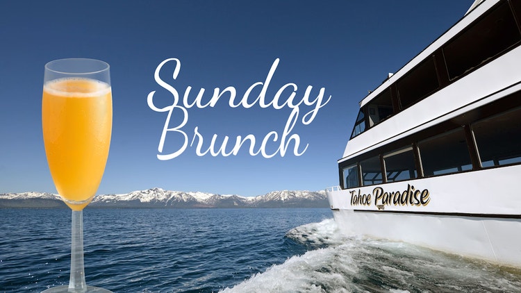 Glass of orange brunch cocktail in the foreground with the Tahoe Paradise yacht cruising on Lake Tahoe, surrounded by snow-capped mountains under a clear blue sky. Text reads