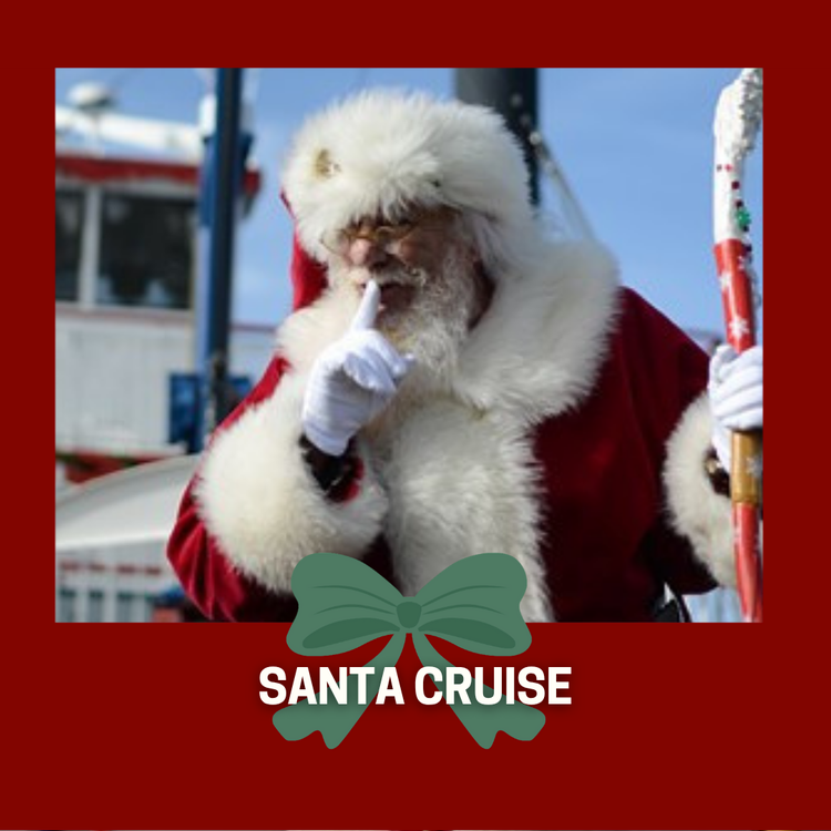 Santa Clause in front of boat holding his finger up to his lips and holing his cane